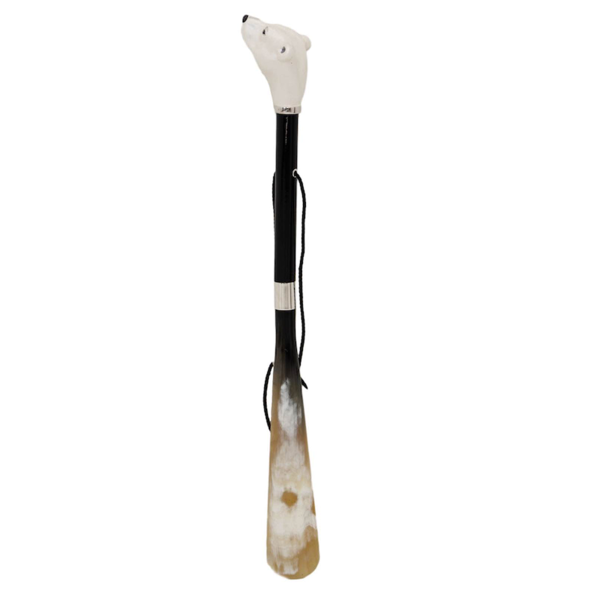 Polar bear shoehorn standing upright: glossy black shaft, hanging cord and natural horn blade