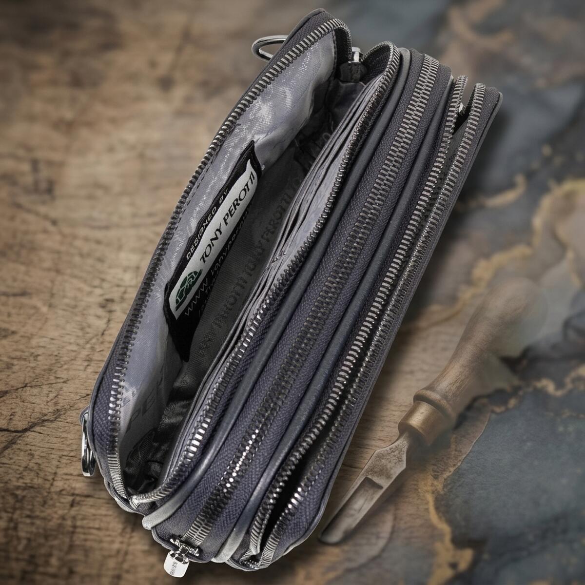 Inside the navy Tony Perotti clutch — printed silk lining and the Designed by Tony Perotti label