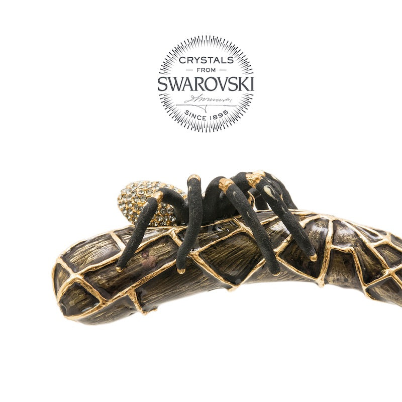 Curved handle in profile: tarantula with matte black legs on a gold-tone web, Crystals from Swarovski seal