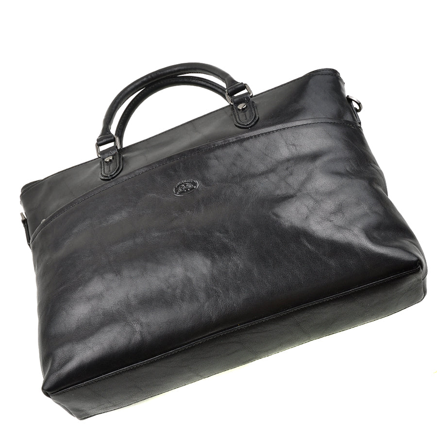 Tony Perotti Italico 7615 nero black leather laptop bag seen from above at an angle — the flat base and the oval Tony Perotti badge on the front