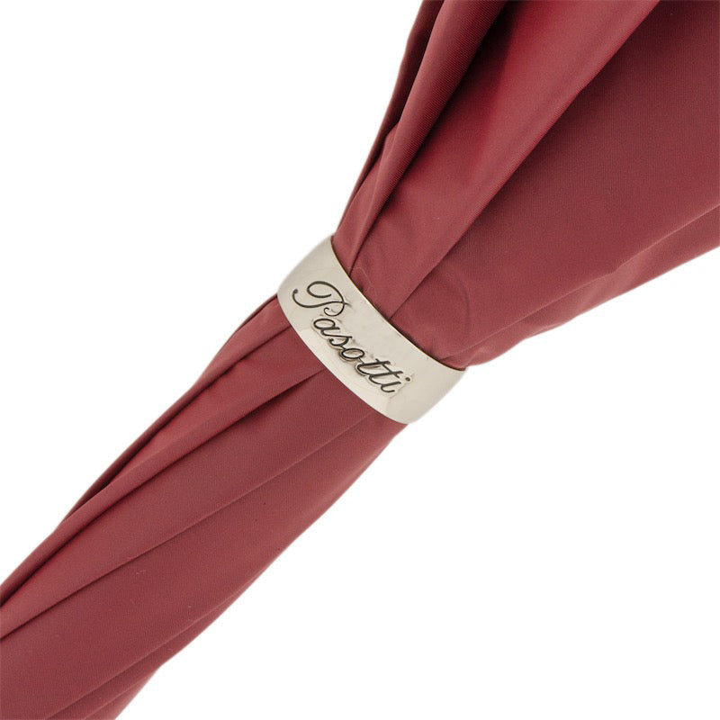 Close-up of the gold Pasotti ring on the burgundy umbrella