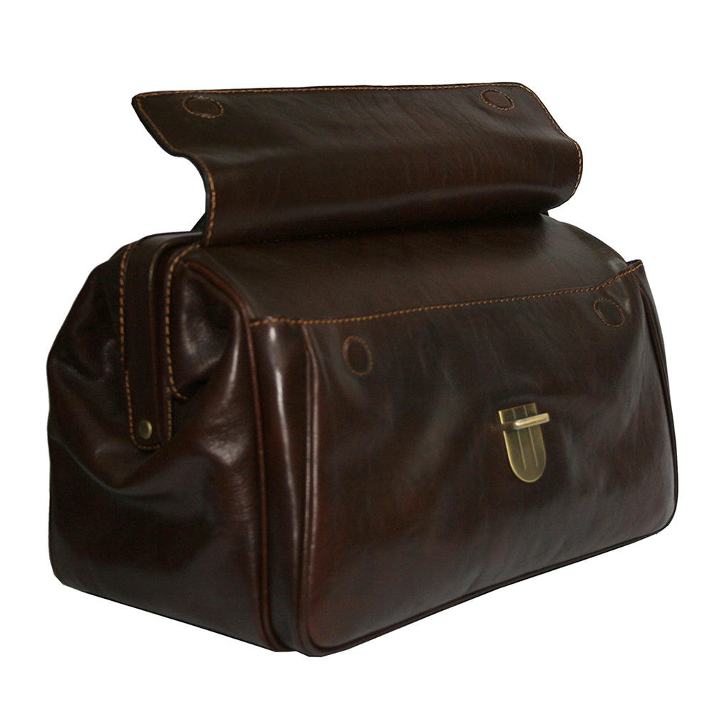 Man in a suit holding the dark brown Tony Perotti Italico 8051 doctor bag by the top handle