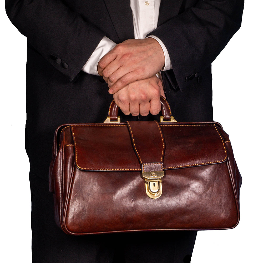 Angled view of the dark brown Italico 8051 doctor bag — deep gusset with snap tab and clasp lock with keyhole