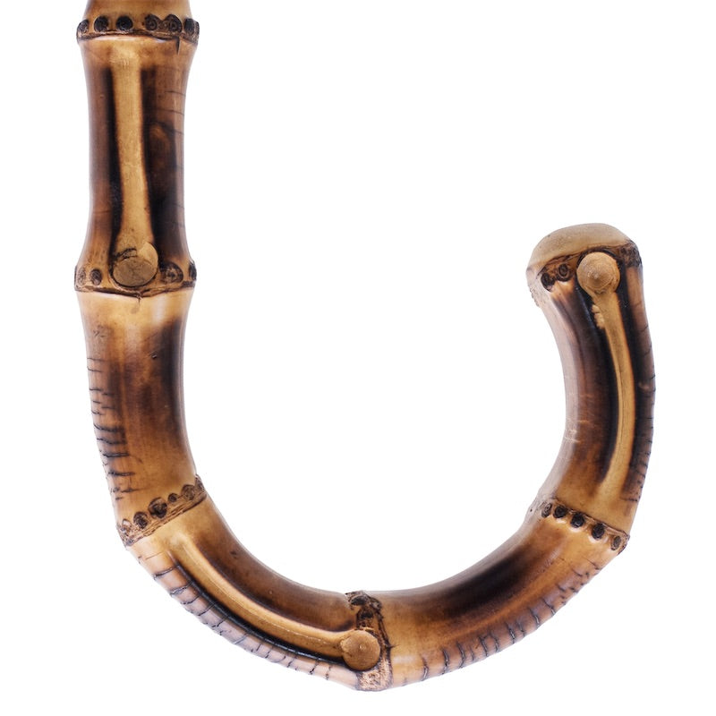 Curved bamboo handle of Pasotti men’s cane umbrella, close-up