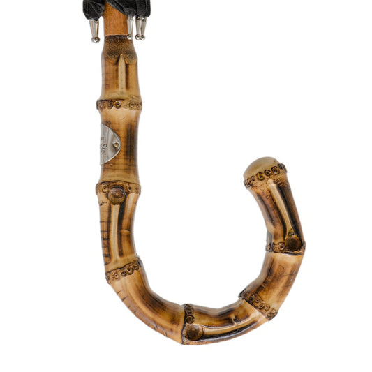 Natural bamboo handle of Pasotti men’s cane umbrella, curved detail