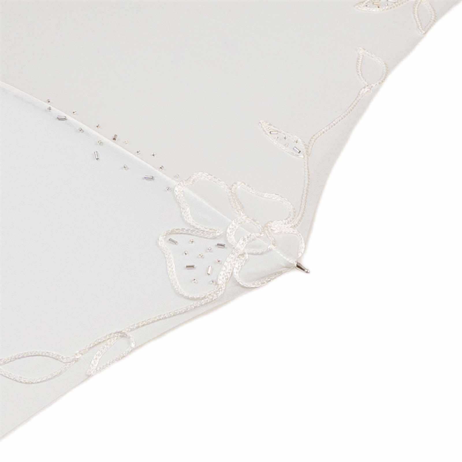 Close-up of embroidered white canopy on Pasotti wedding umbrella