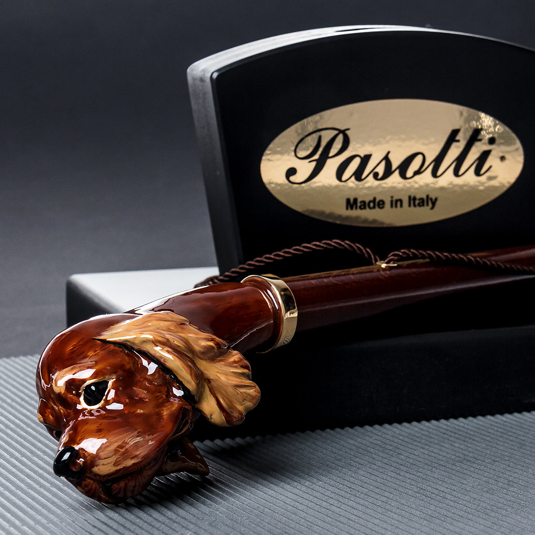 Pasotti shoe horn with a cocker spaniel handle, displayed next to the brand's signature stand