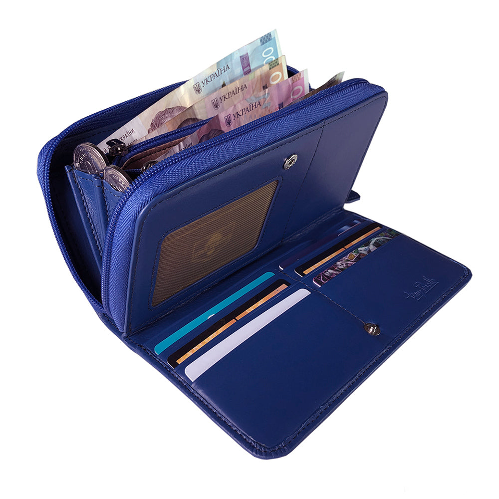 Tony Perotti women’s blue leather zip-around wallet open to show interior compartments with currency and items on a white background