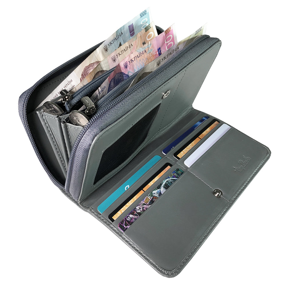 Tony Perotti women's grey leather zip-around wallet with various compartments and currency on a white background