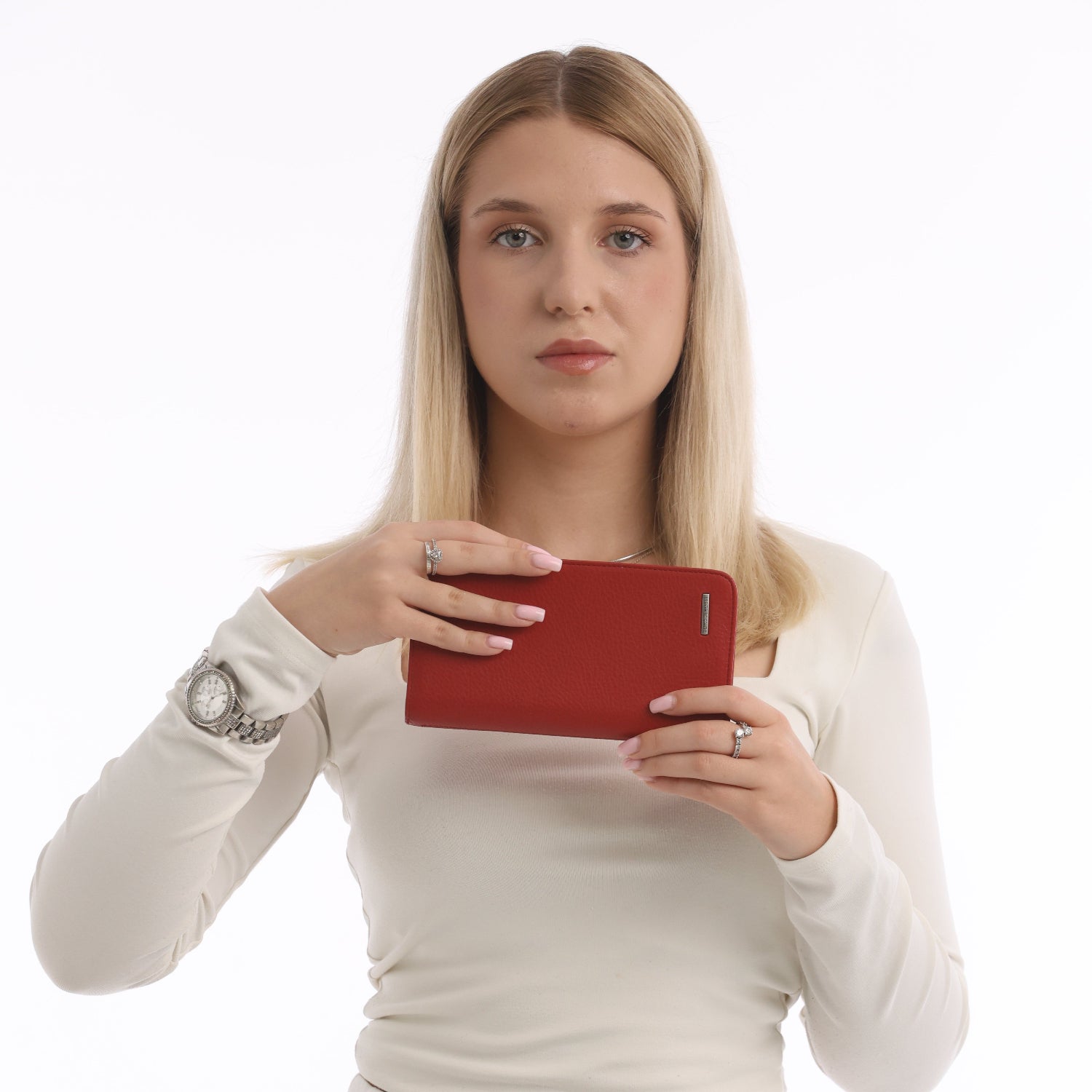 Woman holding a red leather zip wallet against a white background