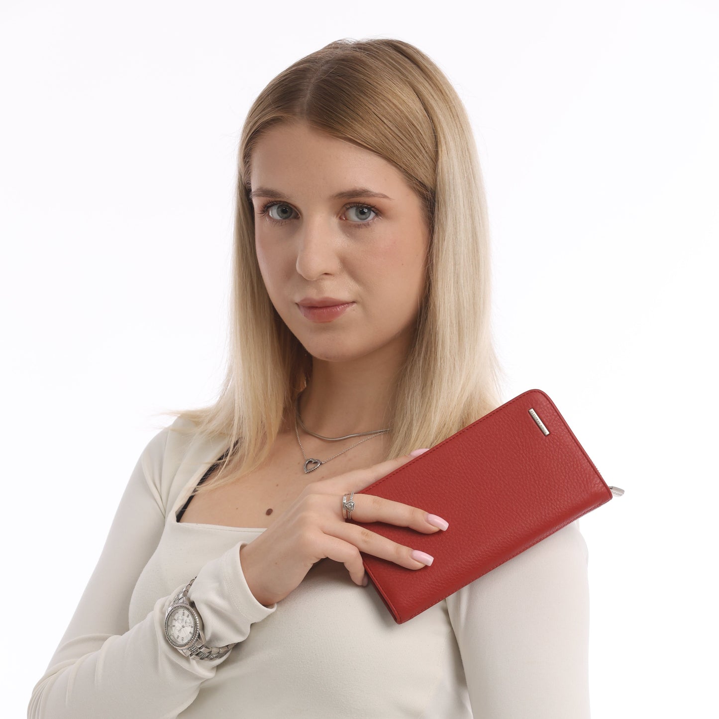 Woman holding a red leather zip wallet against a white background