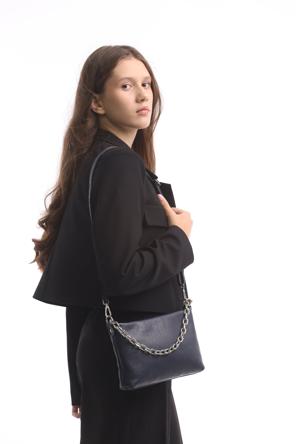 Woman in a black suit carrying the navy Tony Perotti Borsa CA045-01BL bag on its leather strap at hip height