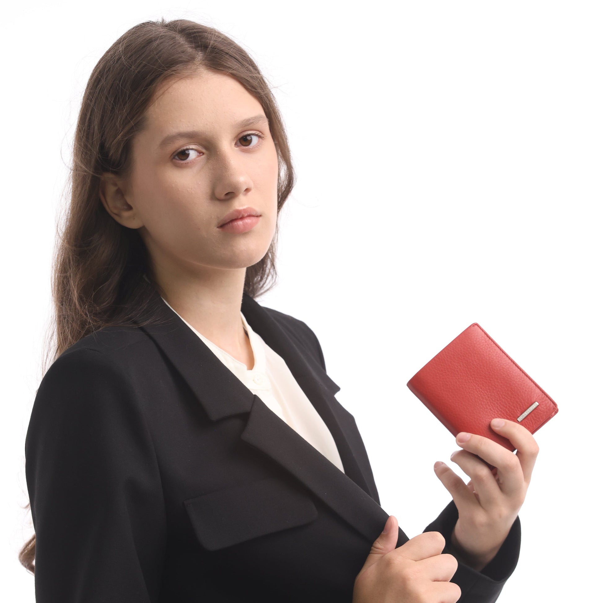 Woman in black suit holding a red wallet on a white background