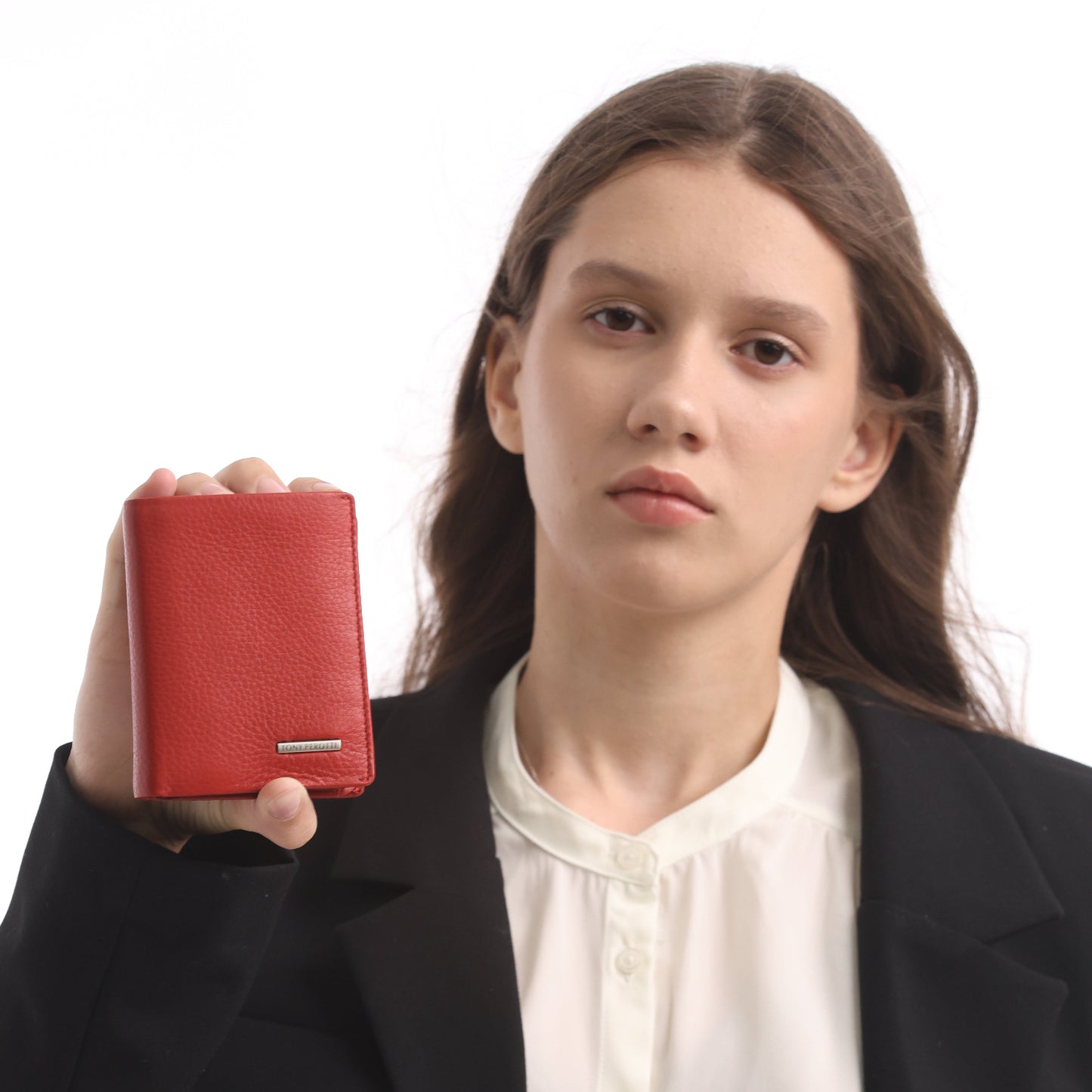 Person holding a red wallet against a white background
