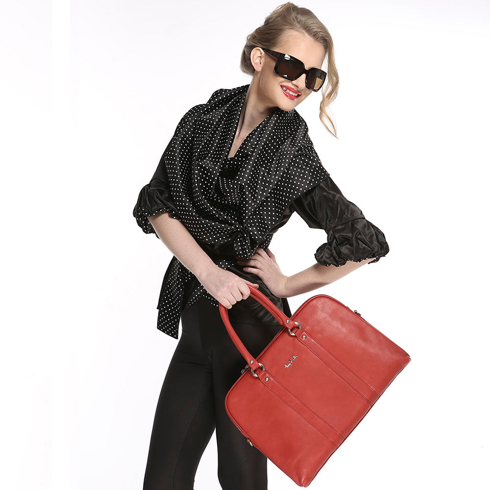The Tony Perotti Contatto 9574-40 rosso briefcase carried at the side, showing its scale against a figure