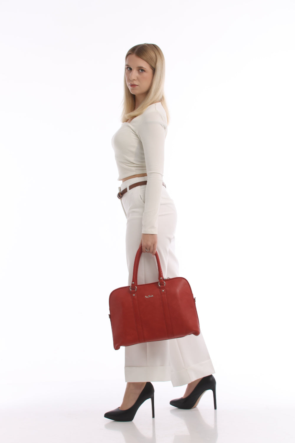 Side view of the Tony Perotti Contatto 9574-40 rosso briefcase carried in the hand, showing the soft domed profile