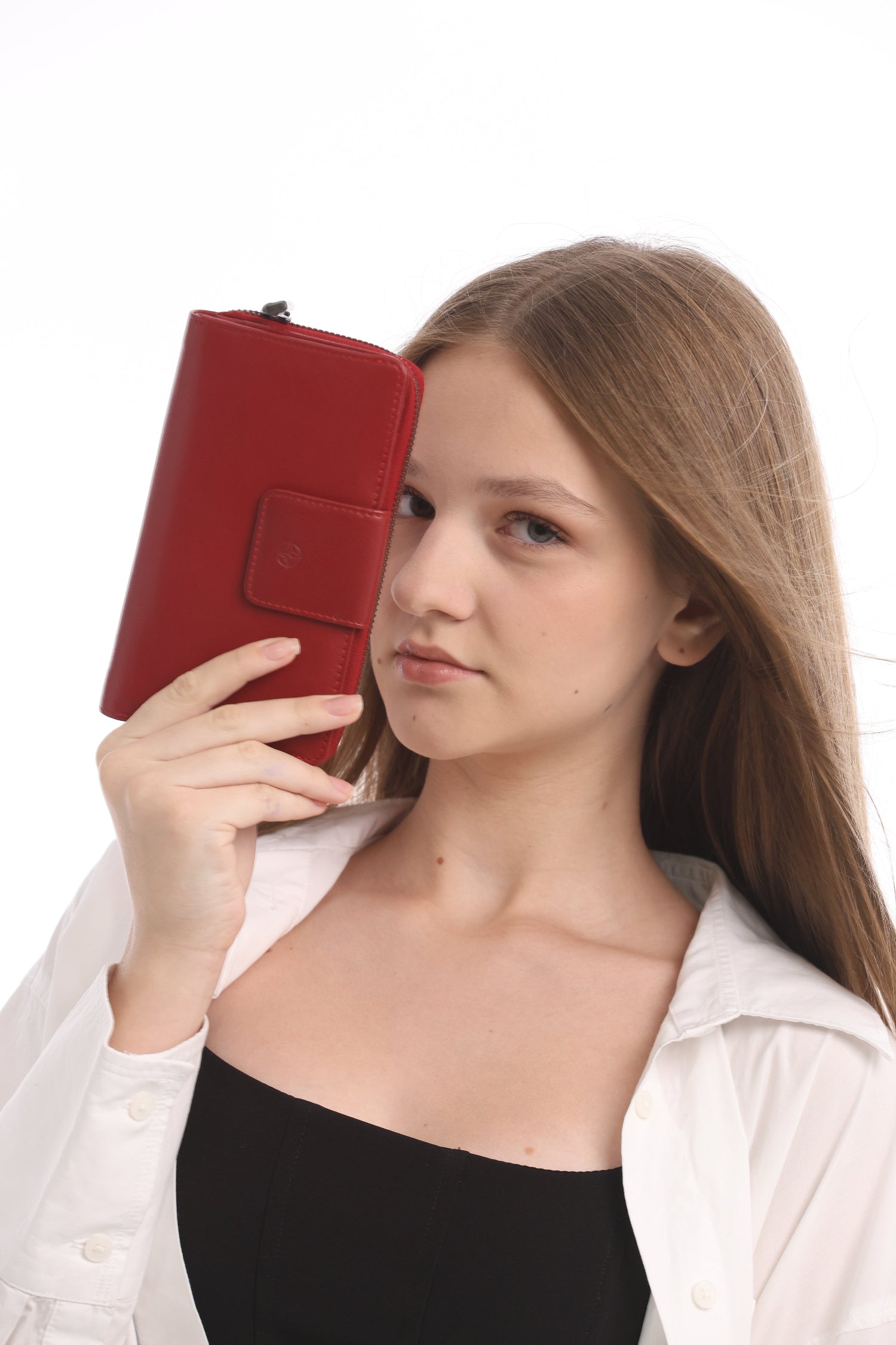 Woman holding Tony Perotti Cortina 5084 Rosso red leather organizer wallet near face