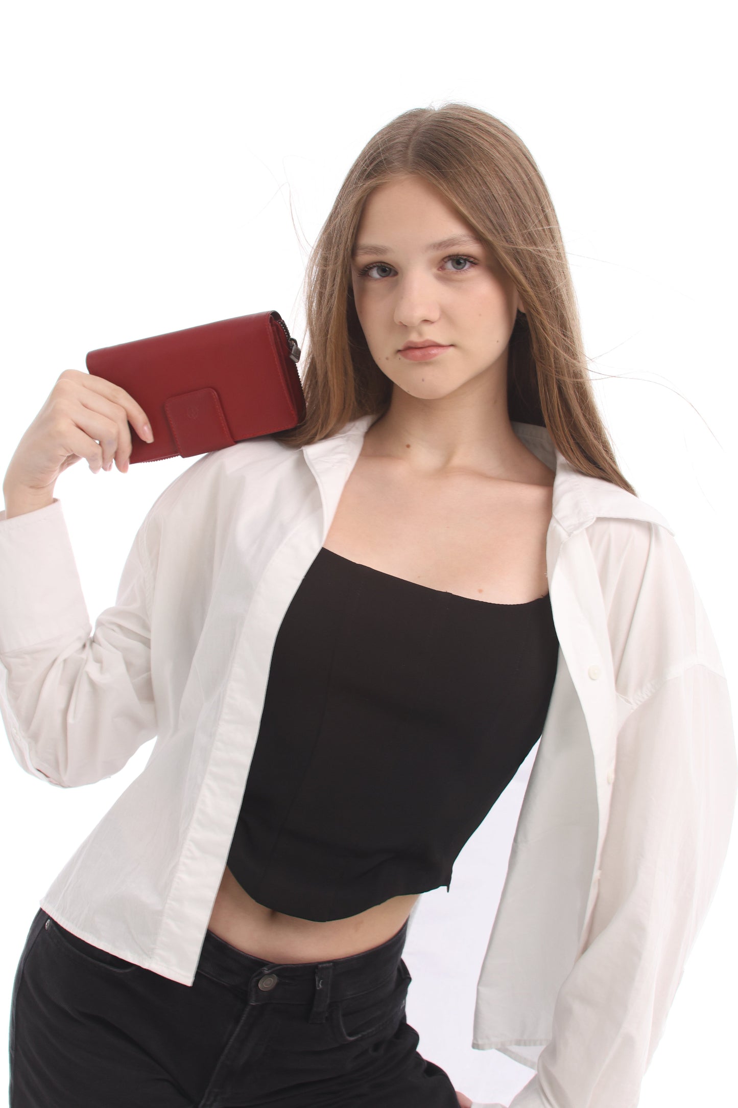 Woman holding Tony Perotti Cortina 5084 Rosso red leather organizer wallet at side