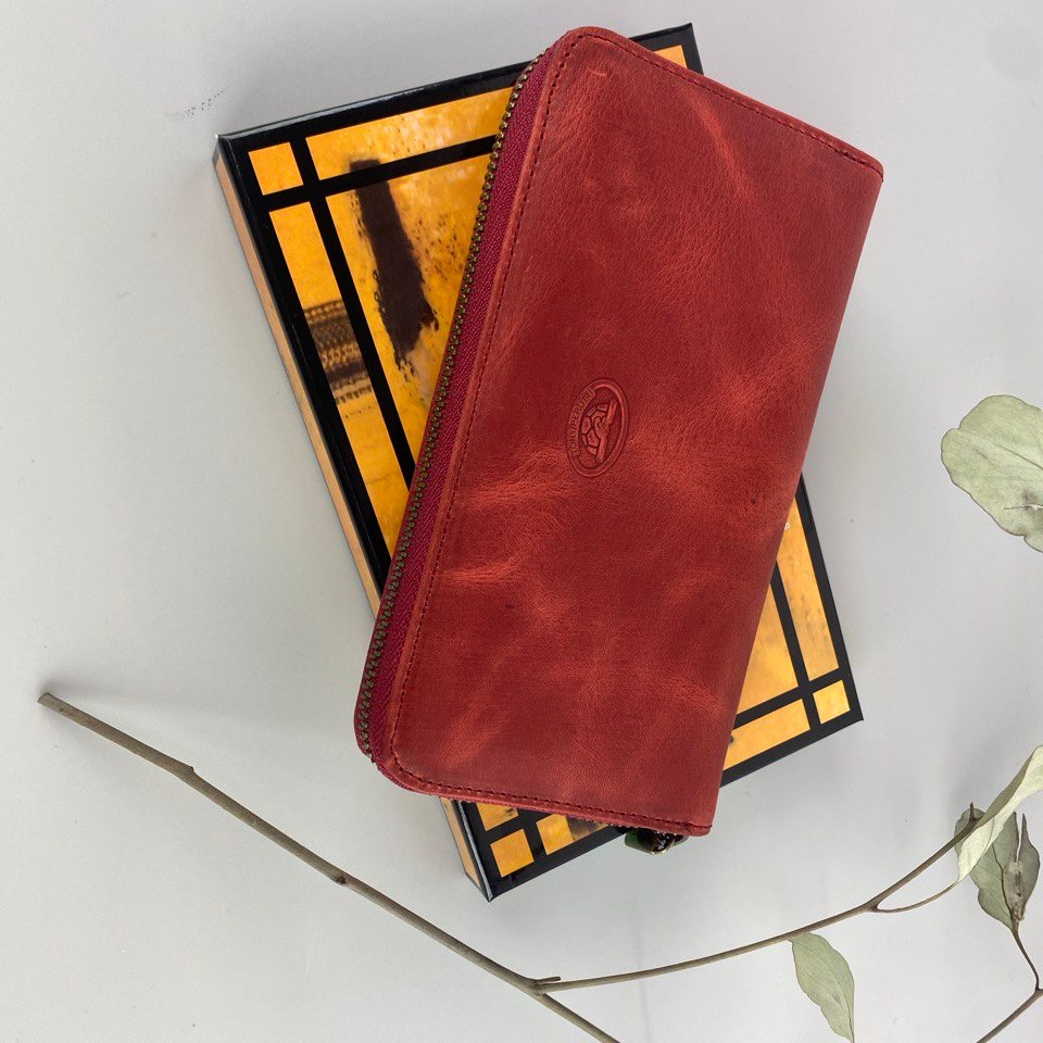 Tony Perotti red vintage-look leather zip-around wallet on a box with a white background
