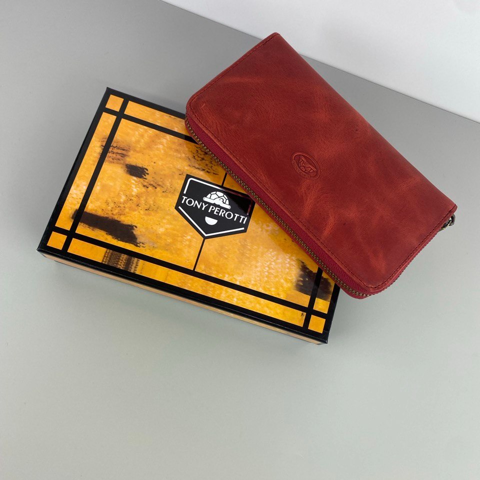 Tony Perotti red vintage-look leather zip-around wallet on a yellow and black branded box