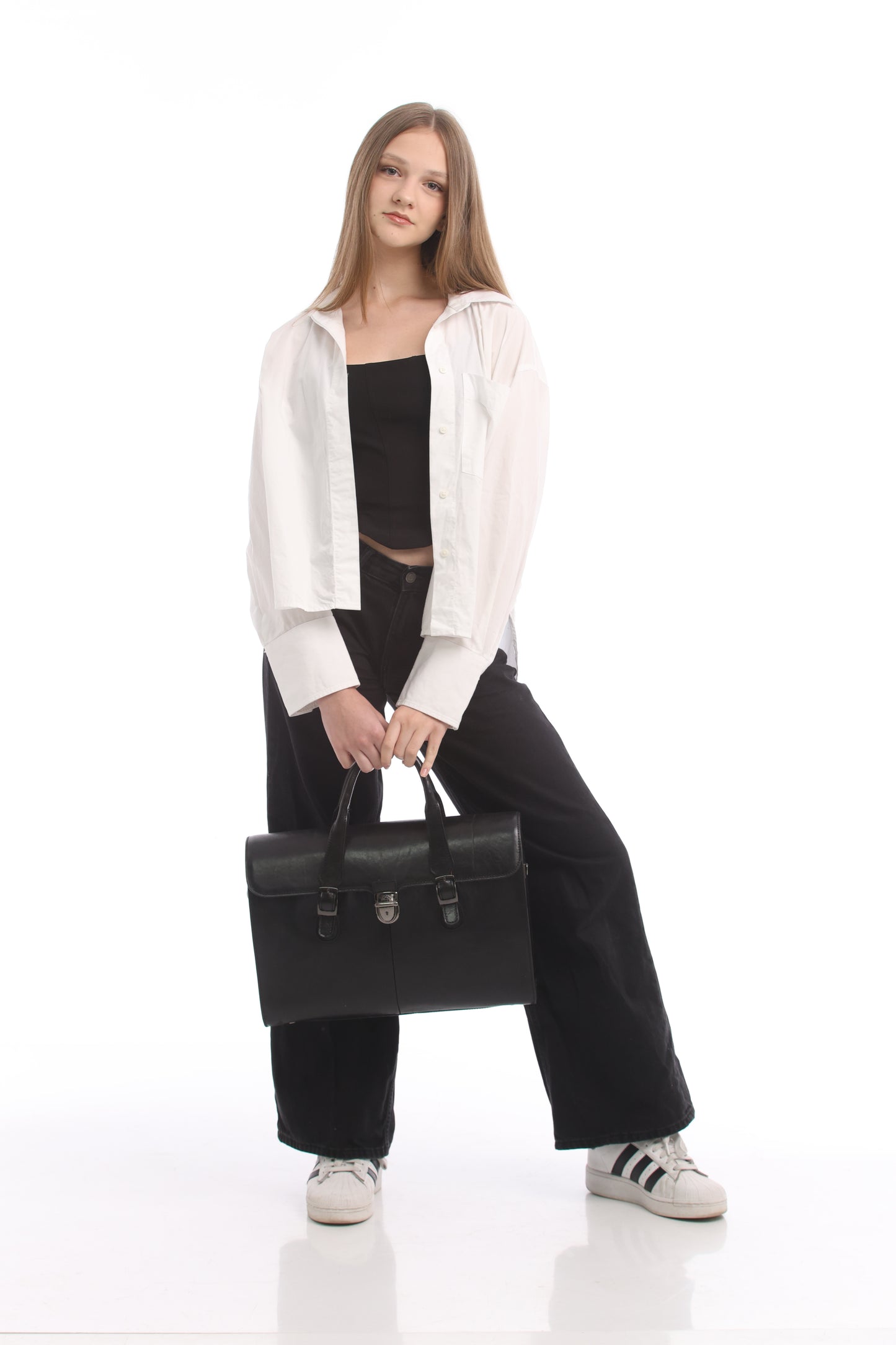 Model holding the black Tony Perotti Italico 8965 briefcase by its twin leather handles, full-length view for scale