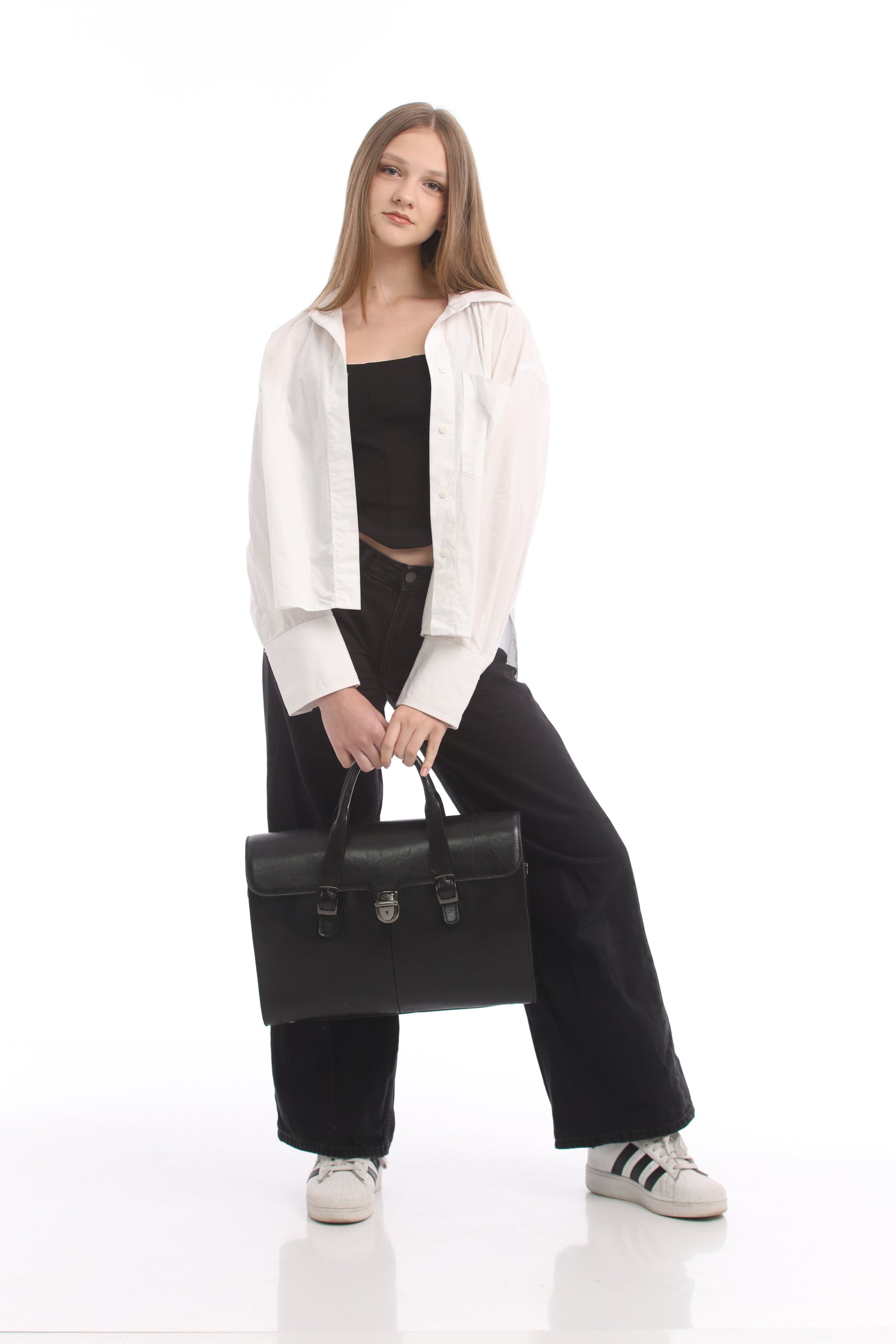 Model holding the black Tony Perotti Italico 8965 briefcase by its twin leather handles, full-length view for scale