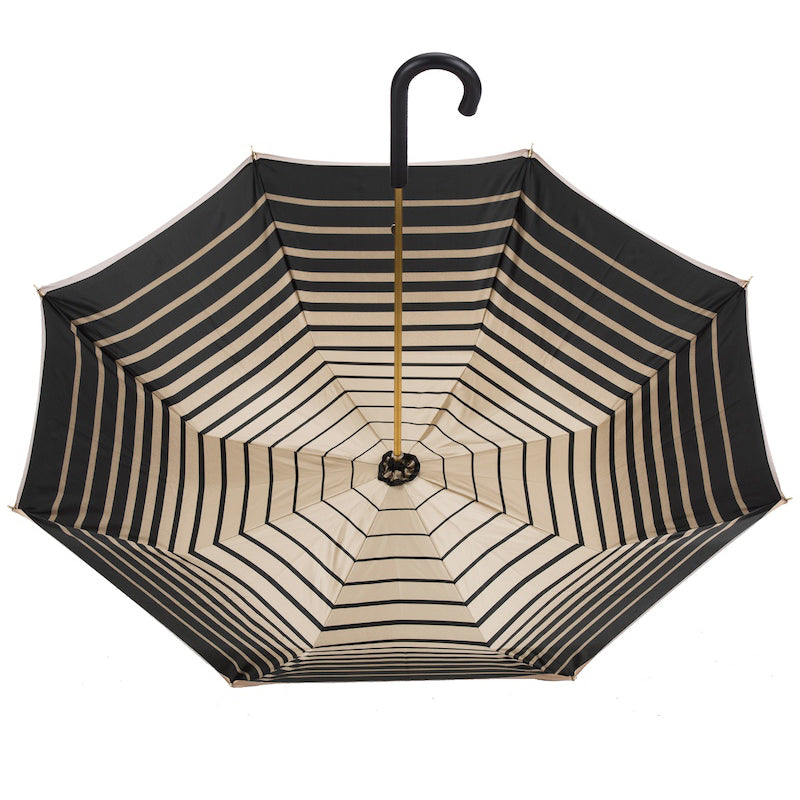 Open dark brown and beige striped umbrella on a white background