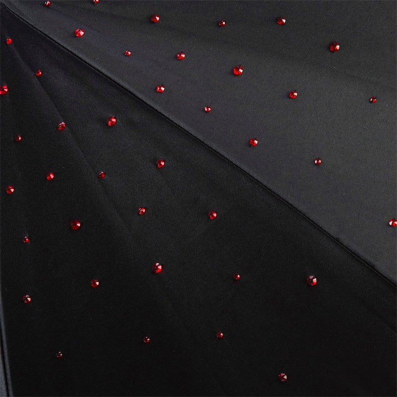 Closed Pasotti black and red cane umbrella with crystal handle
