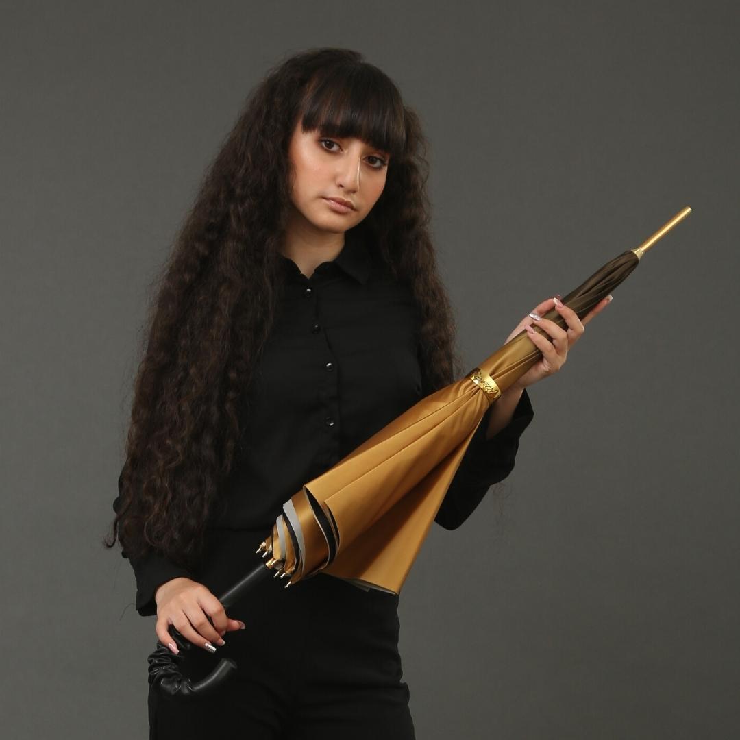 Closed Pasotti bronze floral cane umbrella with elegant silhouette