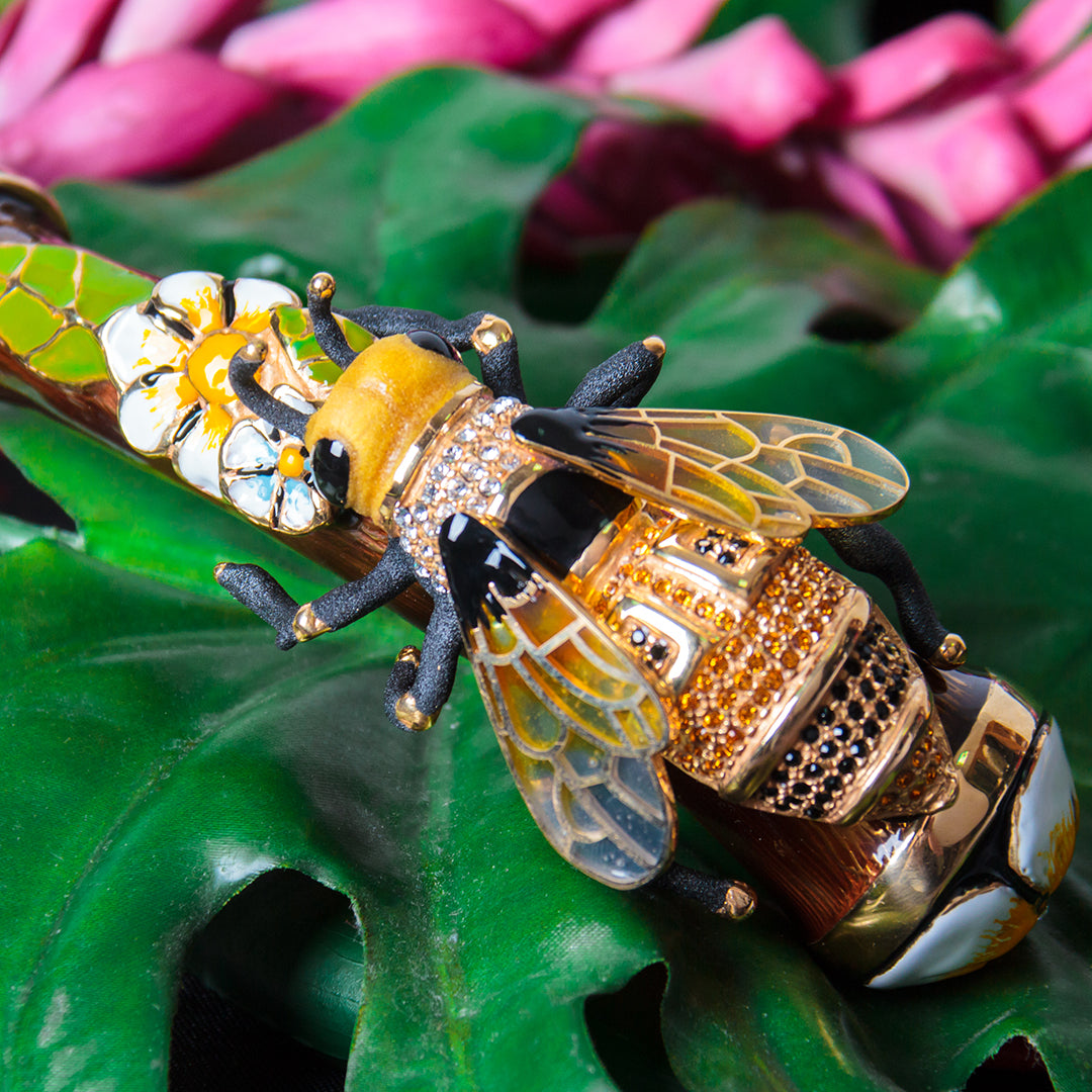 Decorative bee with gemstones on a green leaf
