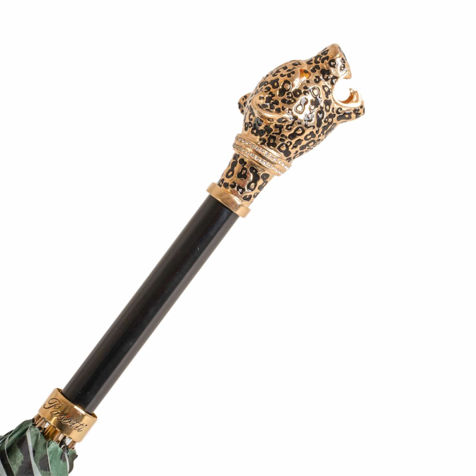 Decorative umbrella cane with leopard head design on a white background