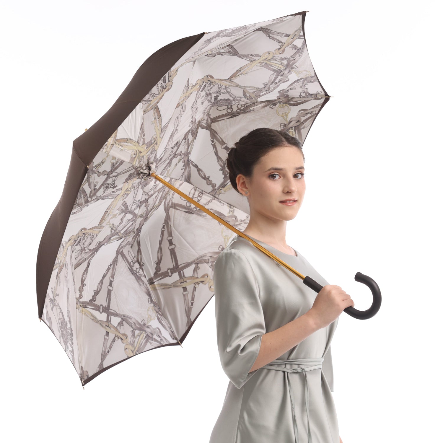 Model holding Pasotti umbrella with equestrian-print lining