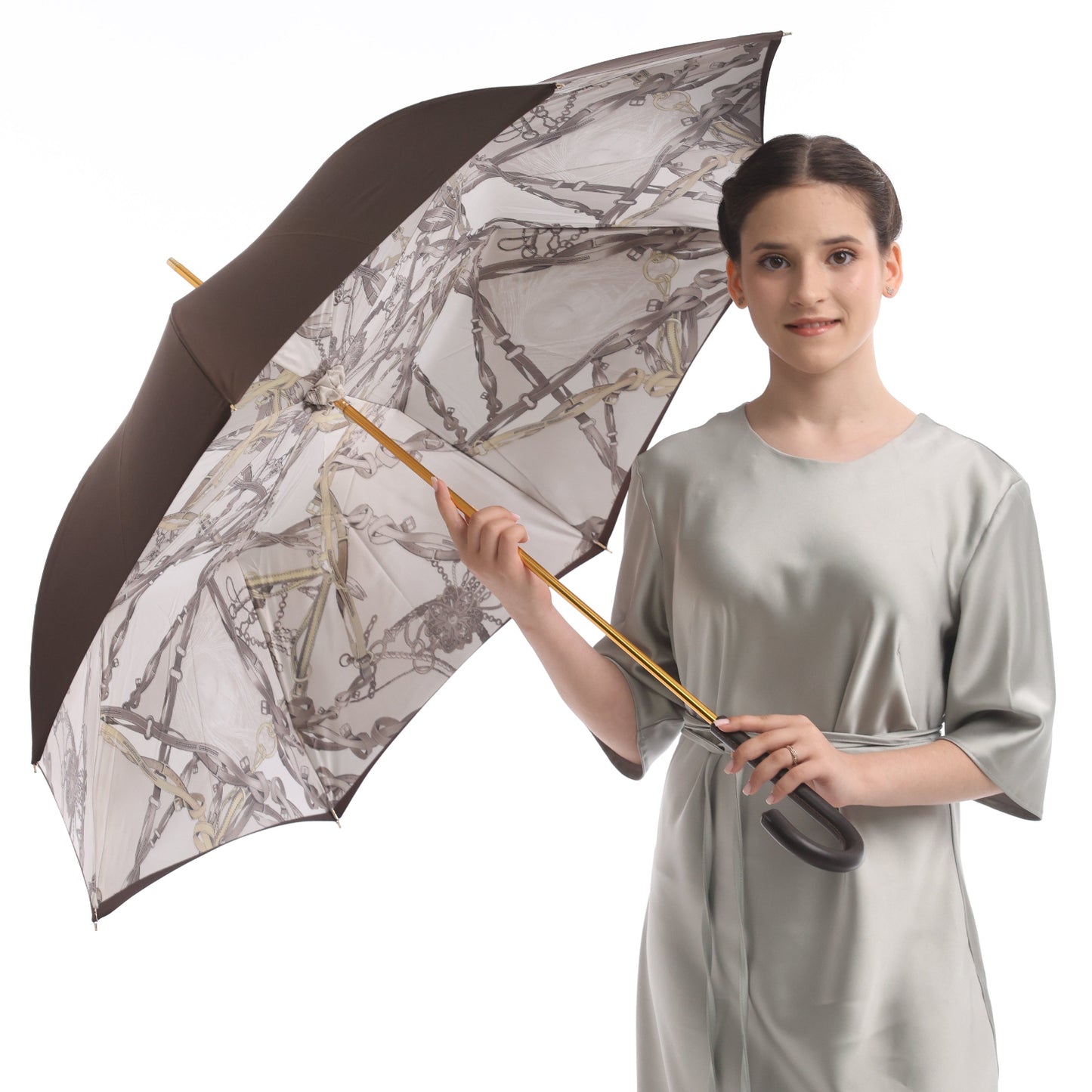Model showcasing the Pasotti women’s brown cane umbrella with an elegant equestrian-print interior