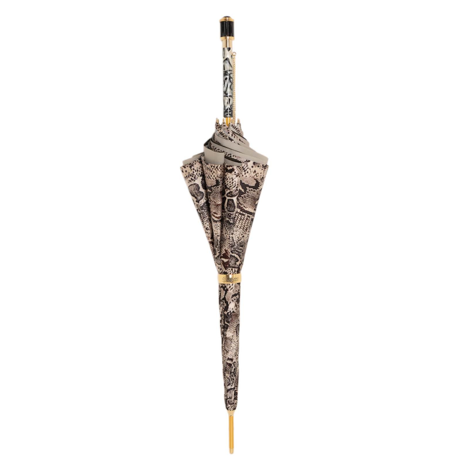 Closed Pasotti python-print cane umbrella standing upright