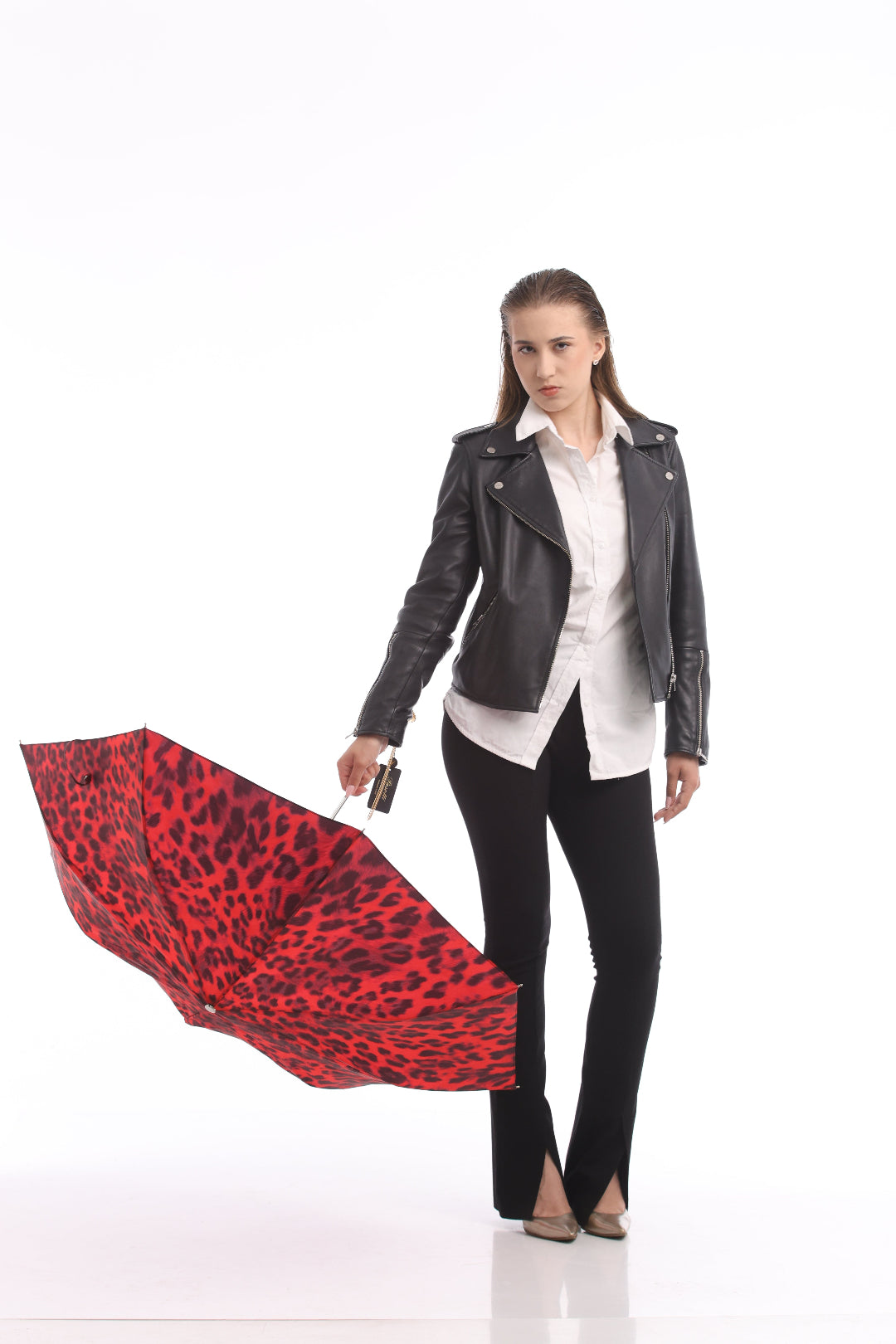 Woman holding a red and black patterned umbrella on a white background