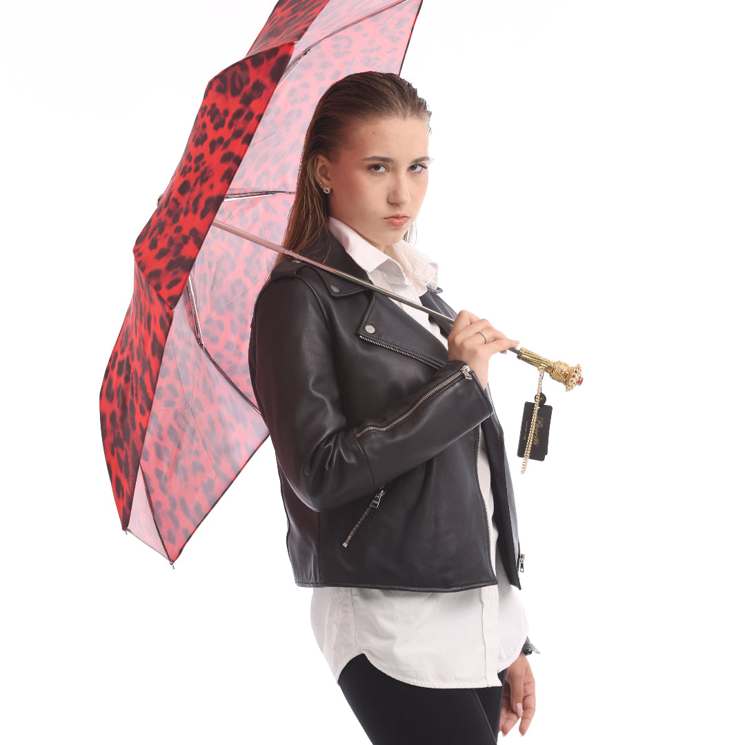 Model holding Pasotti red and black leopard print folding umbrella