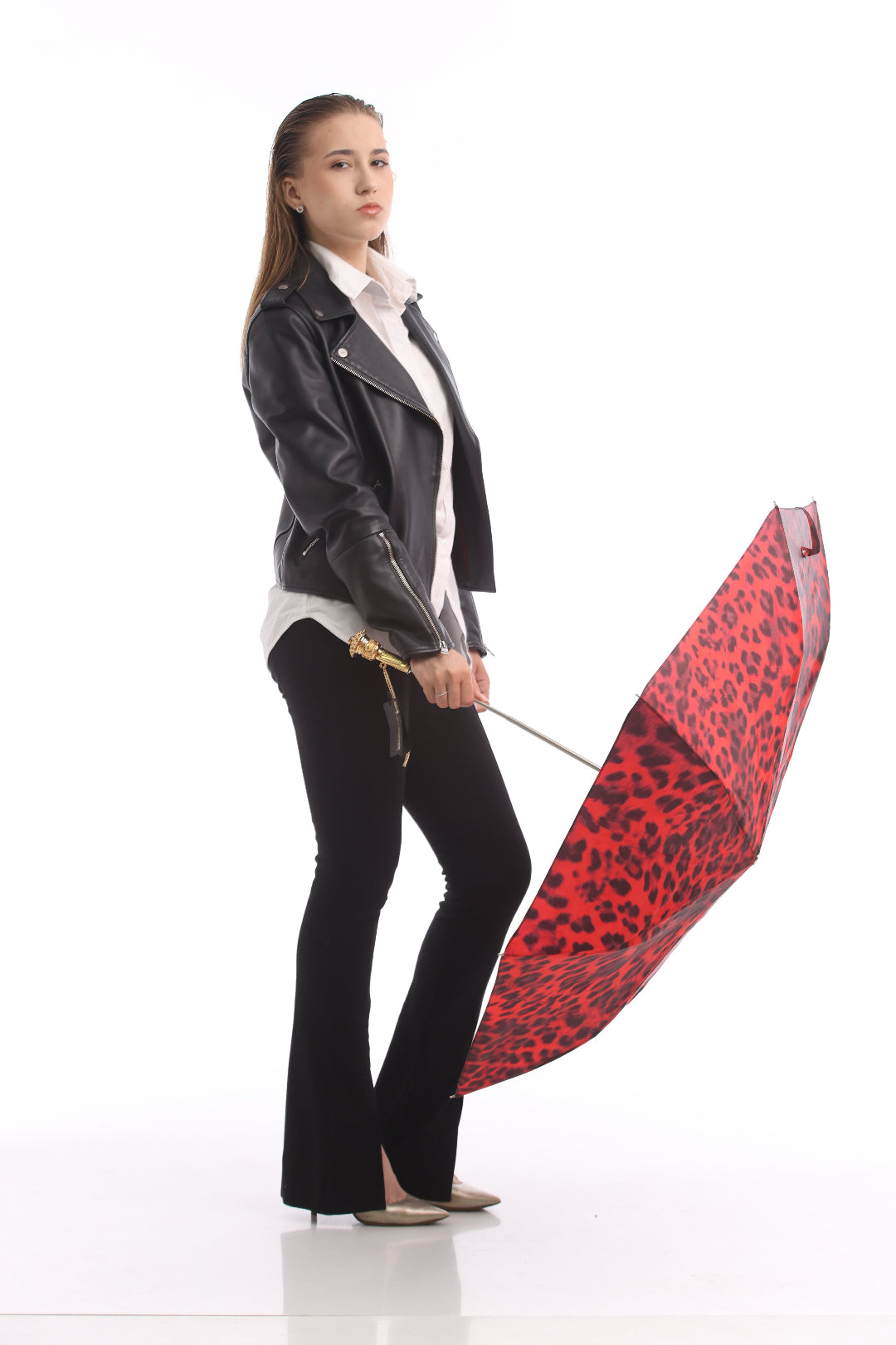 Woman holding open Pasotti leopard print umbrella, full-length view