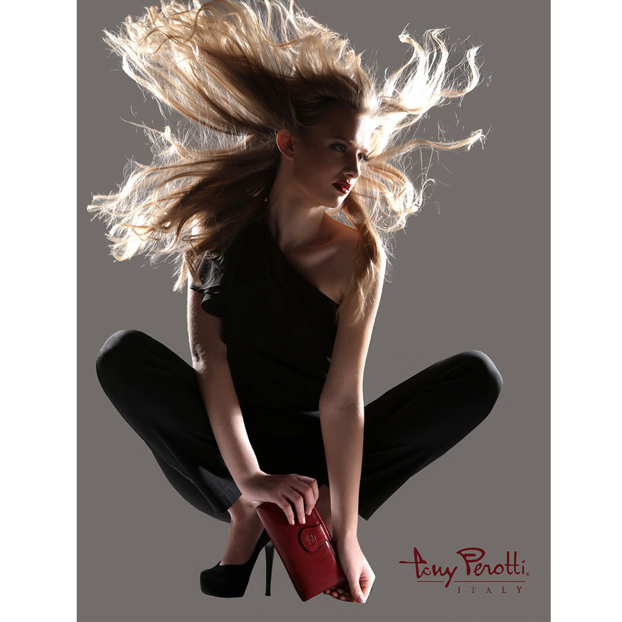 Woman with flowing hair holding a red purse against a gray background, Tony Perotti brand visible