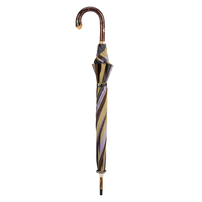 Closed striped umbrella standing upright with the chestnut crook handle