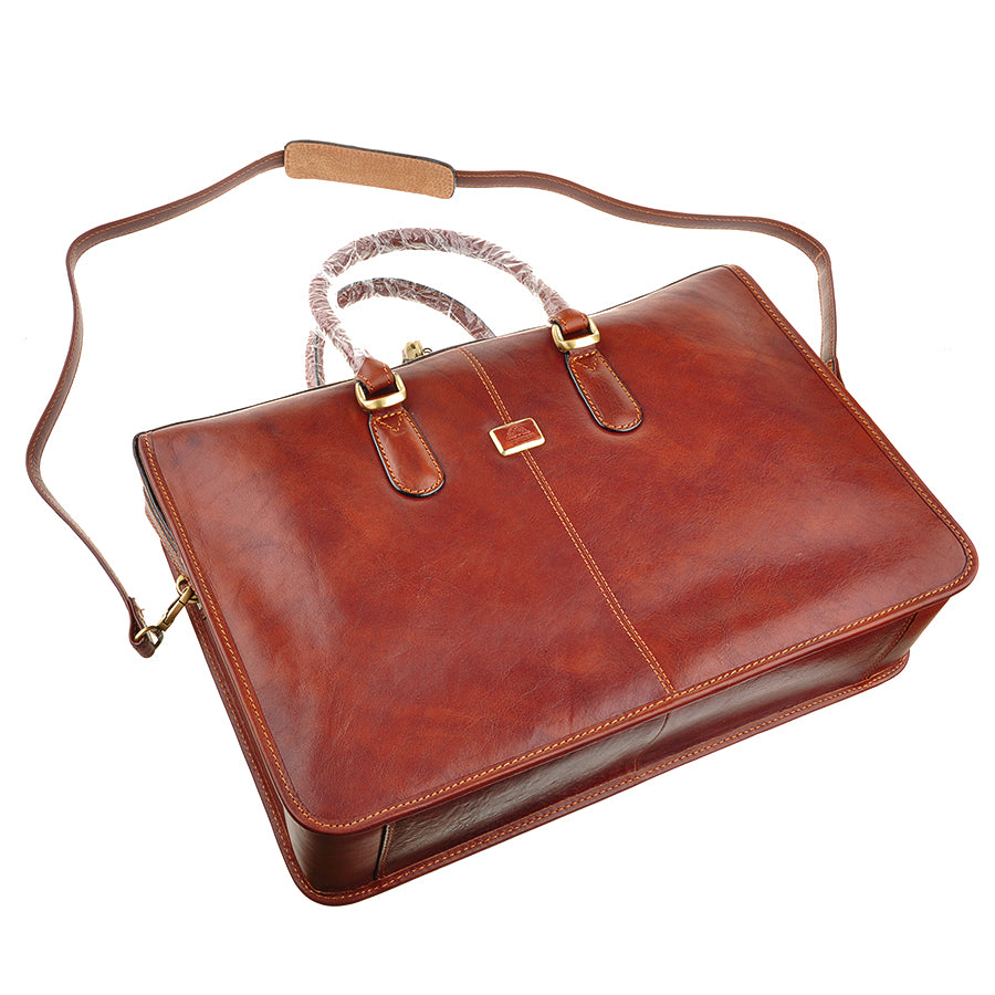 Top view of the Tony Perotti Italico 8098 cognac briefcase with the detachable leather shoulder strap laid out
