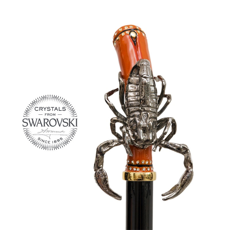 Scorpion handle from the front above a gold-tone collar and black grip, handcrafted in Italy