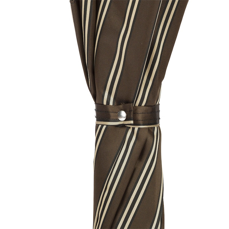Fabric strap with silver-tone snap button on the furled striped canopy