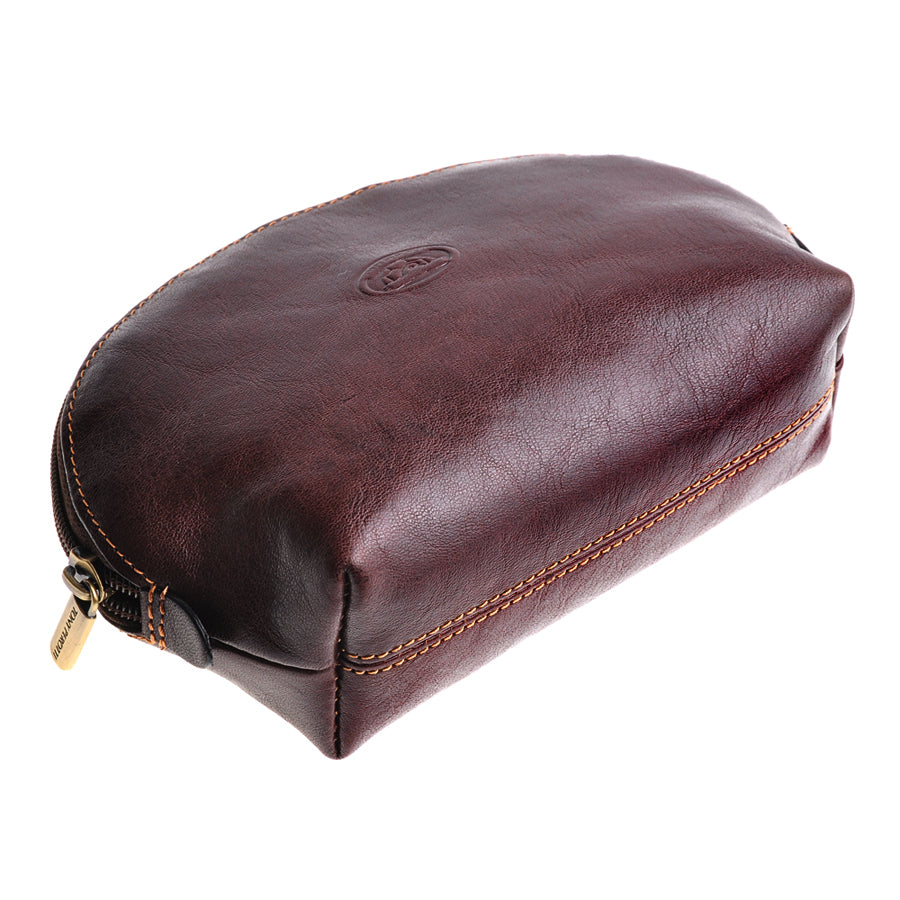 Tony Perotti brown leather cosmetic bag — angled side view showing zip and structured base