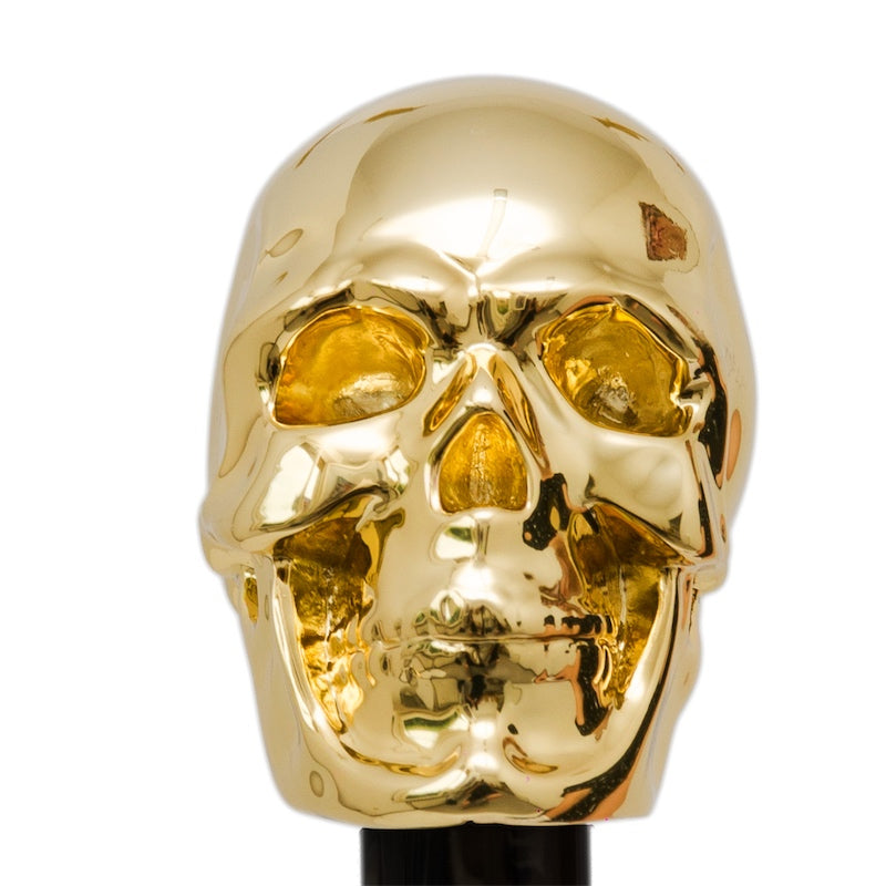 Mirror-polished gold-tone skull handle from the front, close-up, handcrafted in Italy
