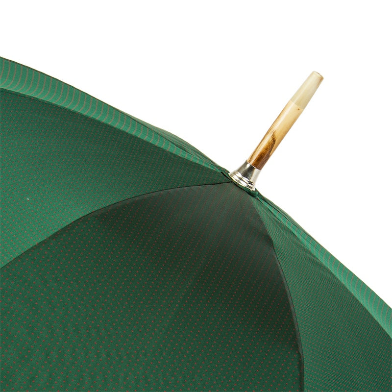 Top of the open green canopy with a light-coloured cap