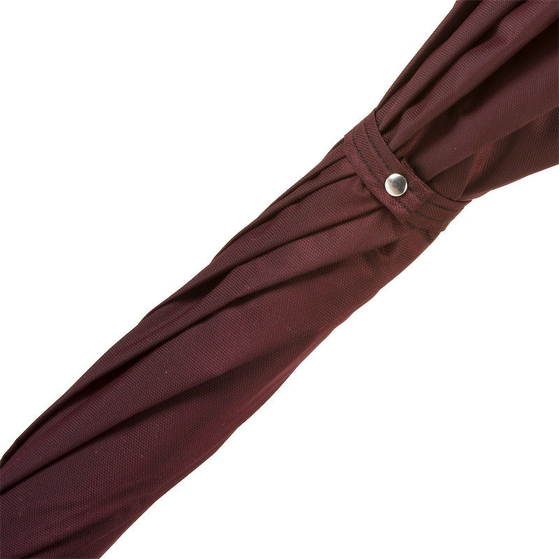 Fabric strap with snap button on the furled burgundy canopy