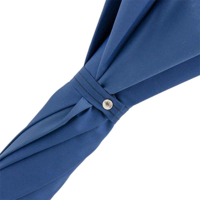 Fabric strap with silver-tone snap button on the furled blue canopy