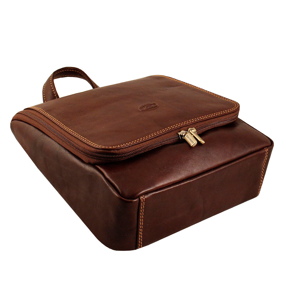 Tony Perotti brown leather hanging toiletry bag — top angled view of wraparound zipper and carry handle