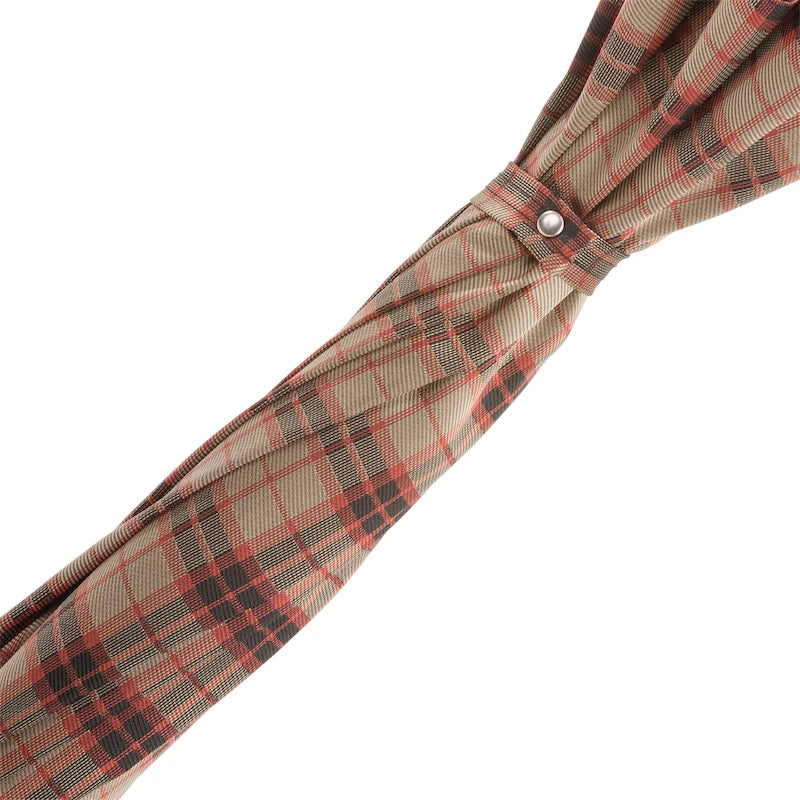 Fabric strap with silver-tone snap button on the furled beige, brown and red check canopy