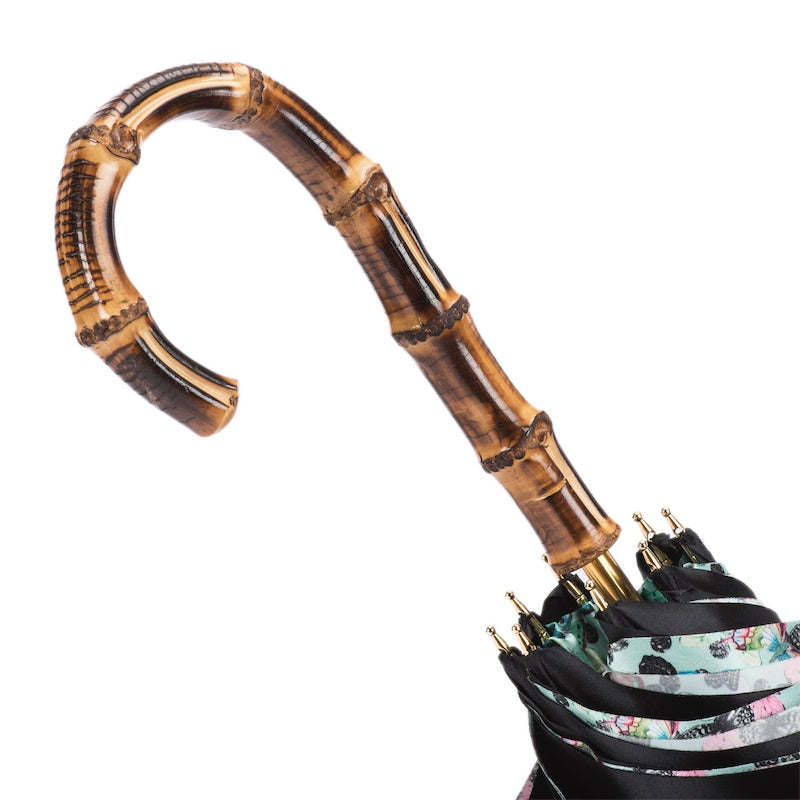 Bamboo crook handle above the furled double canopy with gold-tone rib tips